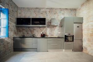 a kitchen with stainless steel appliances in a room at Senglea town house in Senglea