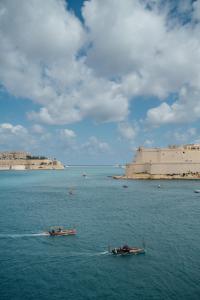 two boats in a large body of water at Senglea town house in Senglea +10 photos