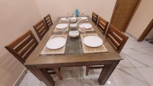 a wooden dining table with four chairs at NewCastle Holidays Resorts-Entire Property 5 Bedrooms-Great Mountain & River View-Between Munnar & Idukki with Kitchen in Idukki