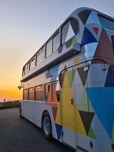 a double decker bus parked in a parking lot at Cornwalls Vintage Camping Bus in Delabole