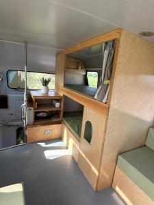ajar view of the interior of an rv with the door open at Cornwalls Vintage Camping Bus in Delabole