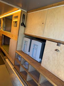 two appliances sitting on a wooden table in a trailer at Cornwalls Vintage Camping Bus in Delabole +20 photos
