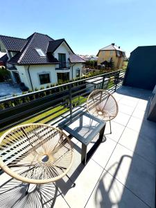 two chairs and a table on a balcony at Port ZS Wrzosowo in Dziwnówek