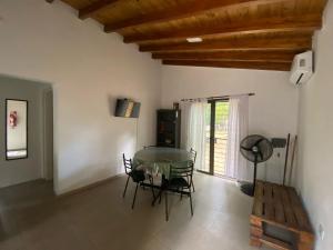 a dining room with a glass table and chairs at Villa Simona in Santa Rosa de Calamuchita