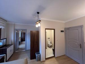 a living room with a toilet and a mirror at Valoria Hotel in Uzungöl +70 photos