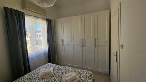 a bedroom with a bed and a large window at Apartman Moris in Malinska
