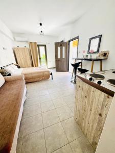 a living room with two beds and a kitchen at Mani Spot in Areopoli