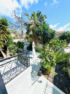 a balcony with palm trees and a staircase at Mani Spot in Areopoli