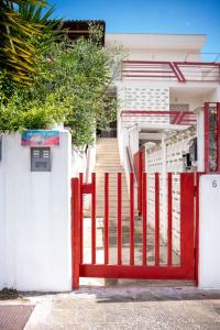 a red gate in front of a house at Sapore di Sale in Margherita di Savoia