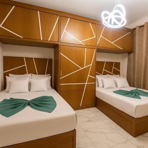 a bedroom with two beds with bows on them at Porto Said Chalets, your perfect family getaway destination in Port Said