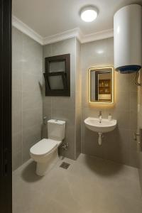 a bathroom with a toilet and a sink at Porto Said Chalets, your perfect family getaway destination in Port Said