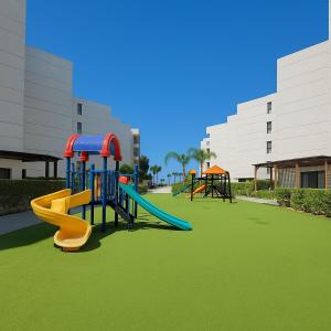 a playground with a slide in a park at Porto Said Chalets, your perfect family getaway destination in Port Said +49 photos