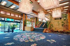 een lobby met een groot tapijt op de vloer van een gebouw bij Fujikawaguchiko Onsen Konanso in Fujikawaguchiko