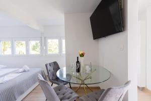 a living room with a glass table and chairs at Digital Nomad Friends in Split +13 photos
