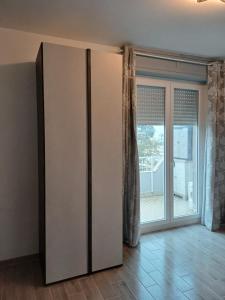 a room with a large sliding glass door at Attico Panoramico Albenga-Appartamento in Albenga