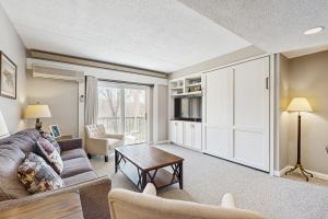 a living room with a couch and a table at Riverview at Rivergreen in Lincoln