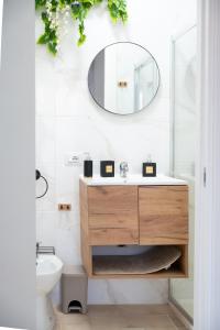 a bathroom with a sink and a mirror on the wall at Sapore di Sale in Margherita di Savoia