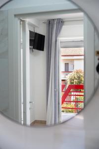 a mirror reflection of a room with a window at Sapore di Sale in Margherita di Savoia