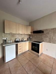 an empty kitchen with a stove and a sink at Raise Cosy Studio with pool in Limassol in Limassol