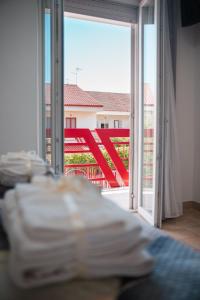 a room with a sliding glass door with a view of a balcony at Sapore di Sale in Margherita di Savoia