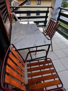 a marble table and chairs on a patio at Cozy Airport Apartments in Velika Mlaka +9 photos