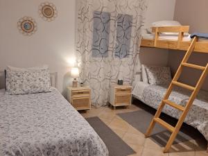 a bedroom with two bunk beds and a ladder at Aegean Villa-On beach apartment! Ideal choice! in Masouri