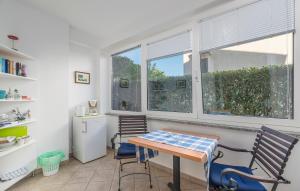 a kitchen with a table and two chairs and a window at Guesthouse Casa Nova in Poreč