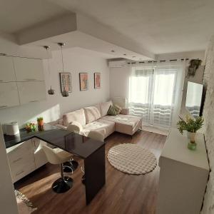 a living room with a couch and a table at Apartament Sikorskiego, klimatyzacja, parking monitoring in Suwałki +8 photos