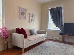 a living room with a couch and a tv at Keur Koura in The Ville in Saint Louis
