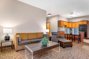 a living room with a couch and a table at Best Western Plus Mill Creek Inn in Salem