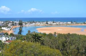 a view of a beach with houses and the ocean at Maison de la Lagune in Oualidia