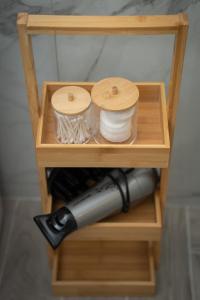 a wooden shelf with a bottle of wine at Lotza apartments in Vrontados