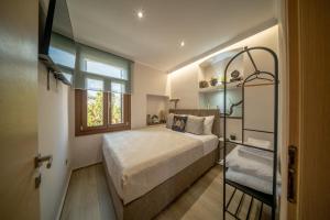 a bedroom with a large bed and a window at Lotza apartment Gyalos in Vrontádos