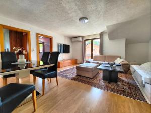 a living room with a couch and a table at Apartment Residence House in Bihać