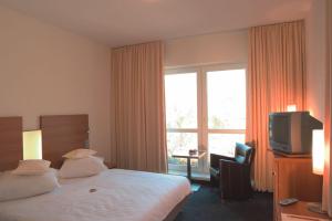 Kama o mga kama sa kuwarto sa Stadthotel Crailsheim