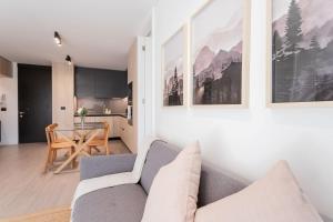 a living room with a couch and a table at Enjoy the Space 2BR 2BA Parque Araucano Sector in Santiago +36 photos