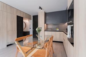 a kitchen with a glass table and two chairs at Enjoy the Space 2BR 2BA Parque Araucano Sector in Santiago