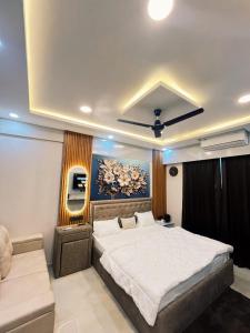 a bedroom with a large bed and a painting on the wall at Celestia hotel in Uttar Pradesh