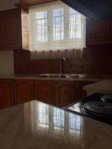 a kitchen with a sink and a window at Stone City Gjirokaster Getaway in Gjirokastër