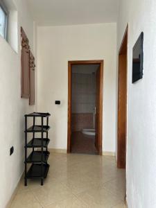 a hallway with a door to a bathroom with a toilet at Stone City Gjirokaster Getaway in Gjirokastër