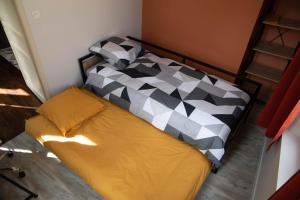 a bedroom with a bed with a black and white comforter at Cathedral Spark in Troyes
