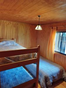 Llit o llits en una habitació de Turismo Jaos Cabañas Tinas y Quincho