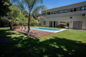 a house with a swimming pool in a yard at Casa Robles in Pilar