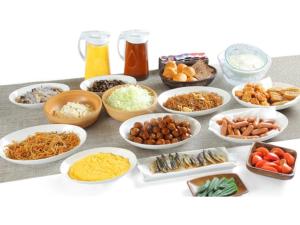 a table topped with bowls of different types of food at Smile Hotel Fukuoka Okawa - Vacation STAY 80017v in Ōkawa +18 photos