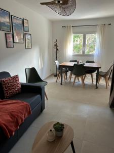 a living room with a couch and a table at Maison typique de village in Sorbo-Ocagnano