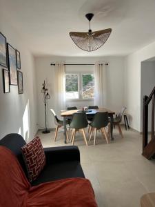 a living room with a couch and a table and chairs at Maison typique de village in Sorbo-Ocagnano +16 photos