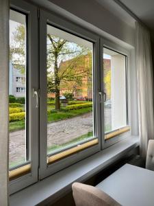 a window with three views of a street at Przy ZAMKU in Malbork