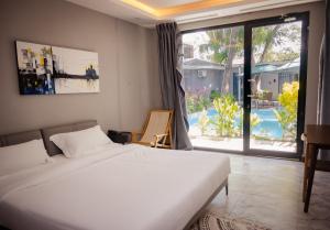 a bedroom with a bed and a view of a pool at The L Boutique Tz in Dar es Salaam +34 photos