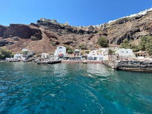 a body of water with a group of white buildings at Chalaris Armeni Villa in Oia