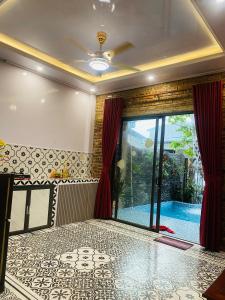 a room with a swimming pool and a large window at Sunshine villa thuan an in Hue +36 photos